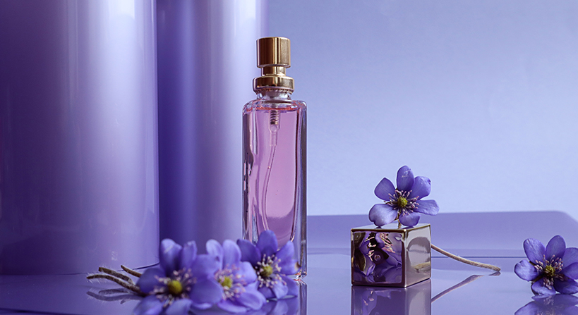 Eco-friendly fragrance packaging with purple perfume bottle and floral design accents