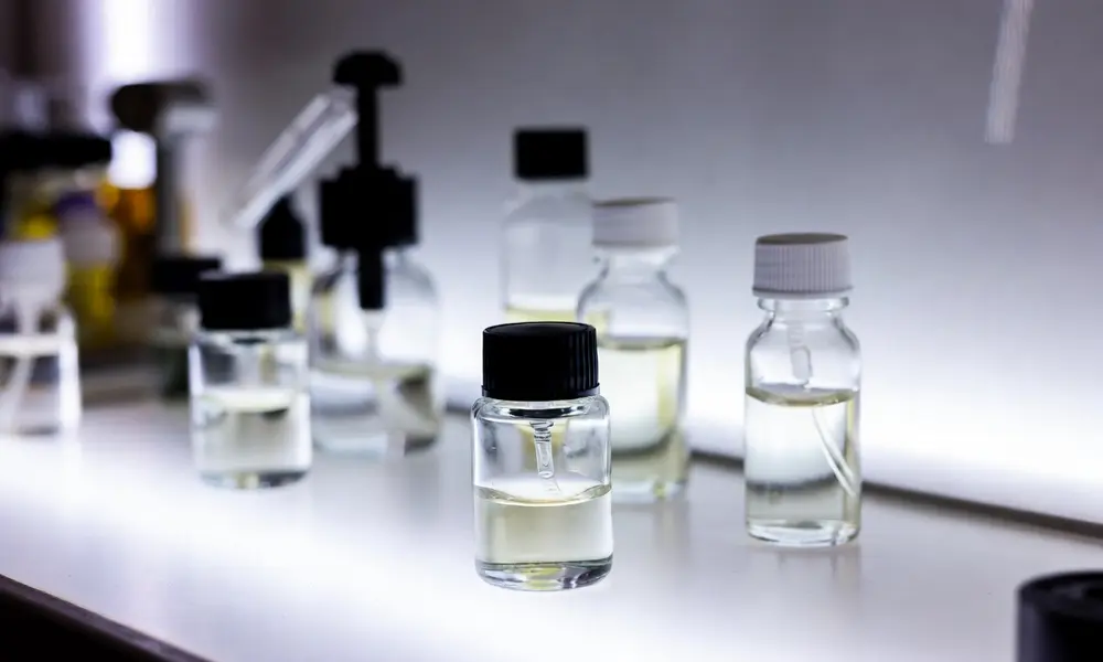 Clear glass sample bottles used for testing fragrance oil and ethanol compatibility.